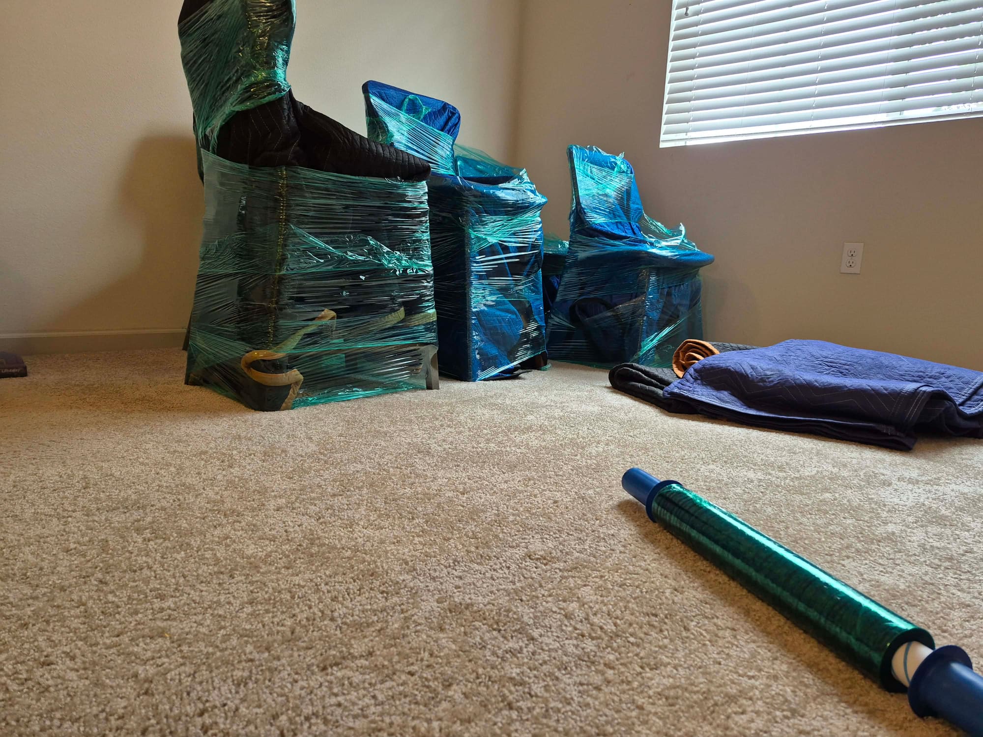 Professional packing supplies and wrapped furniture by Mighty Movers San Diego